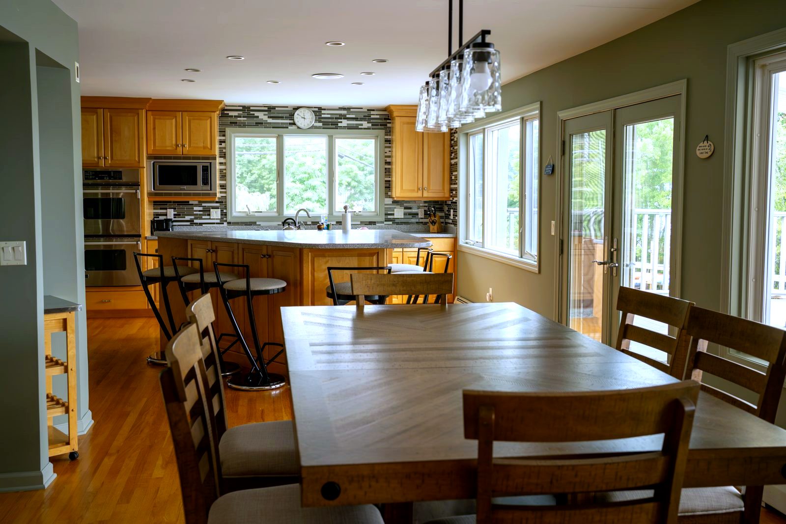 Dining table and kitchen island with the lake beyond