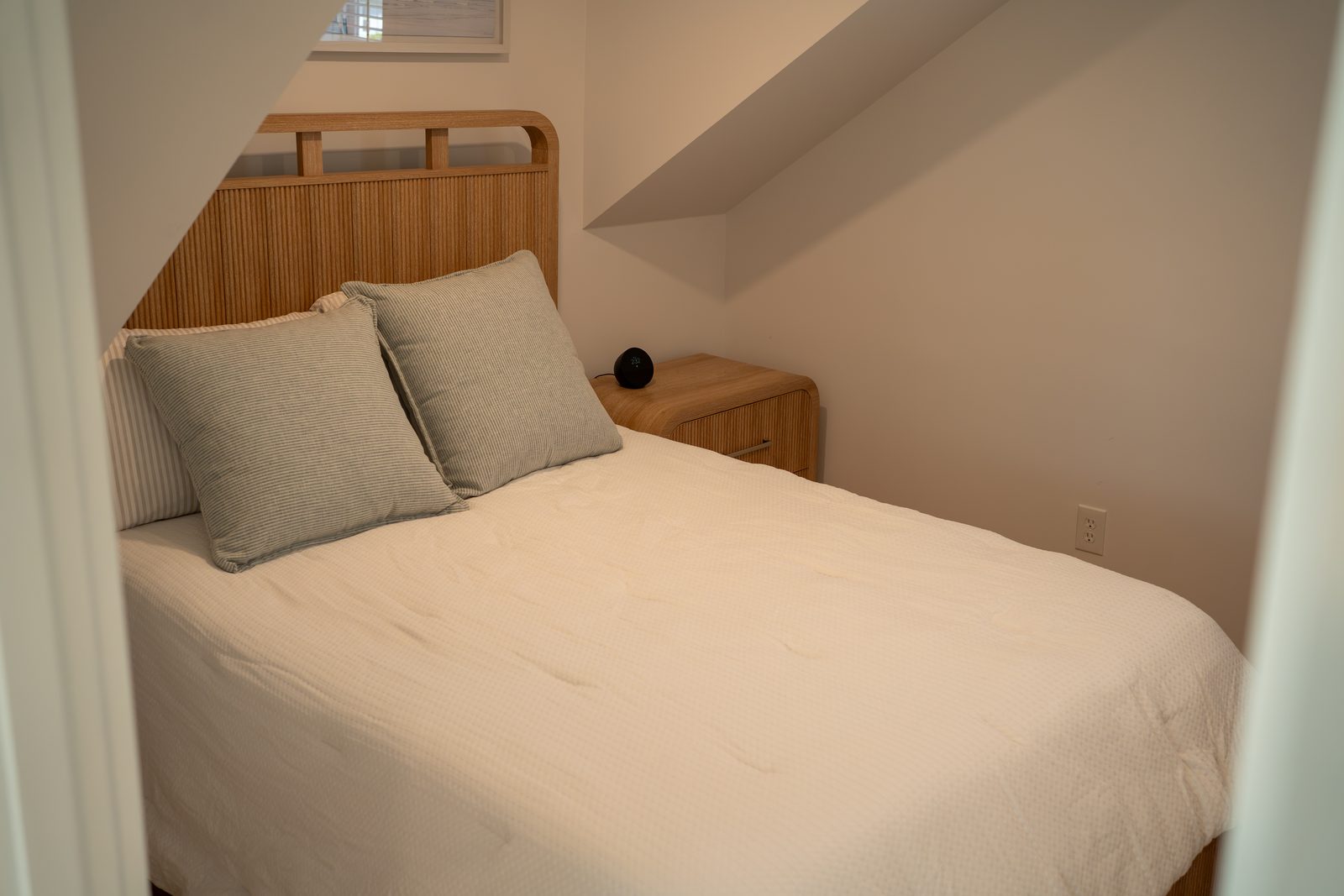 Queen bedroom under the sloped ceiling